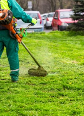 A,Worker,In,High,Visibility,Clothing,Maintains,Public,Spaces,,Expertly