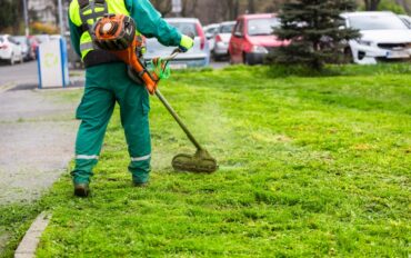 A,Worker,In,High,Visibility,Clothing,Maintains,Public,Spaces,,Expertly