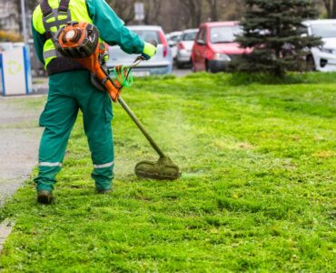 A,Worker,In,High,Visibility,Clothing,Maintains,Public,Spaces,,Expertly