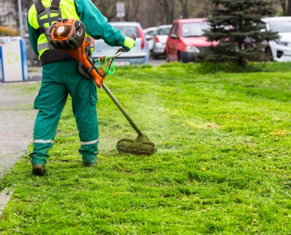 A,Worker,In,High,Visibility,Clothing,Maintains,Public,Spaces,,Expertly