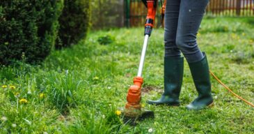 Woman,Cutting,Grass,At,Backyard.,Electric,Grass,Trimmer.,Lawn,Care