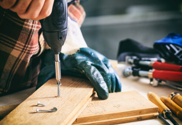 Power,Electric,Screwdriver.,Carpenter,Working,With,A,Hand,Tool,On