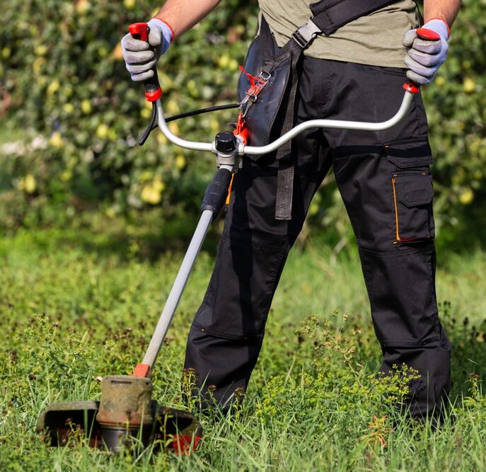 Gardening,Concept.,Man,Cutting,The,Lawn,With,Grass,Trimmer.