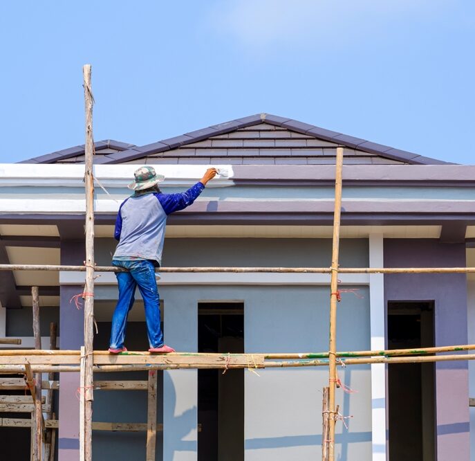 Asian,Construction,Worker,On,Wooden,Scaffolding,Is,Painting,Roof,Structure